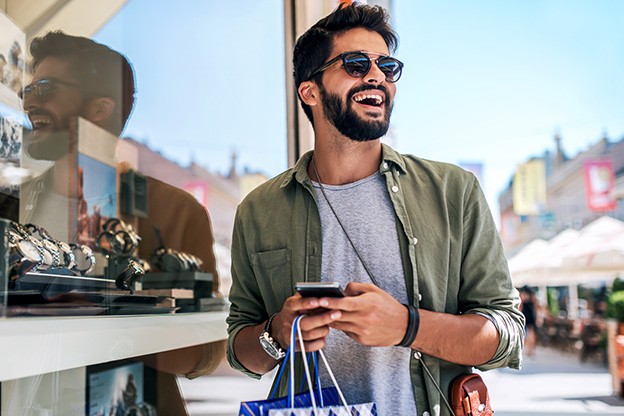 Man smiling while shopping outside