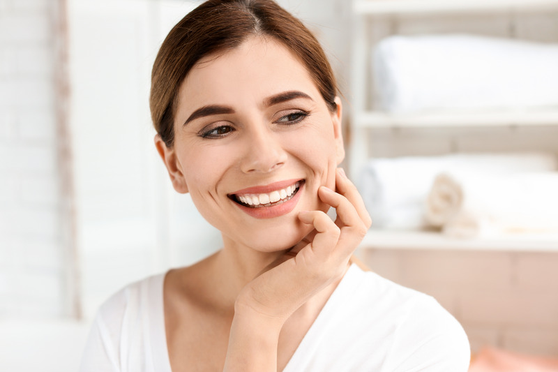 Patient smiling at work after a smile makeover